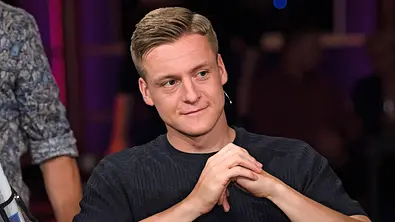 Felix Kroos sitzt mit gefalteten Händen in einer Talkshow - Foto: IMAGO / STAR-MEDIA