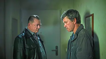 Peter Kurth (l.) und Peter Schneider stehen mit trauriger Miene in einem Flur.  - Foto: MDR/Felix Abraham