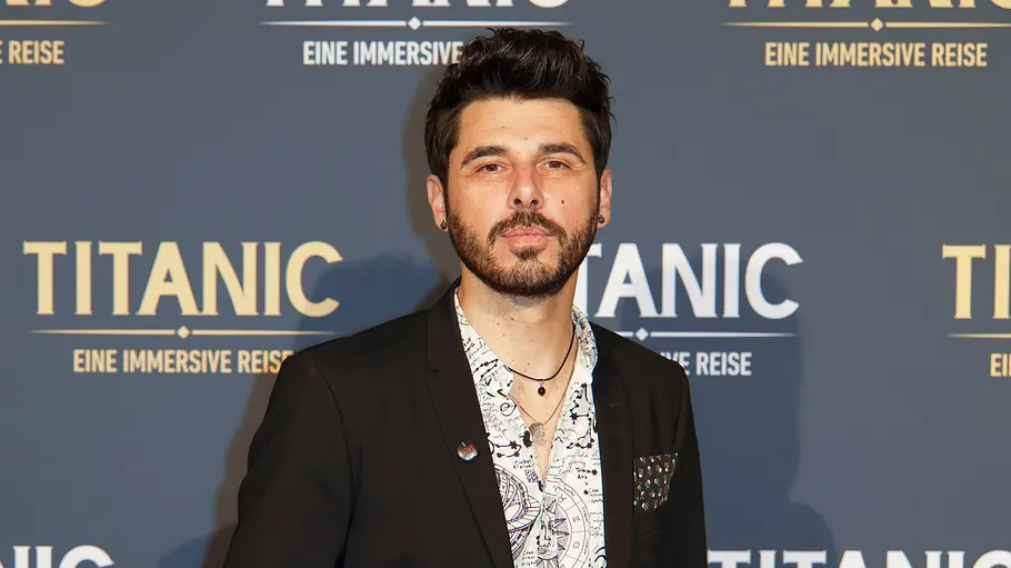Riccardo Angelini auf einem Red Carpet. Er hat einen neutralen Gesichtsausdruck