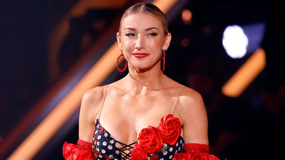 Anna-Carina Woitschack bei „Let’s Dance“ Anna-Carina Woitschack steht in einem rot-schwarzen Tanzoutfit auf der „Let’s Dance“-Bühne.