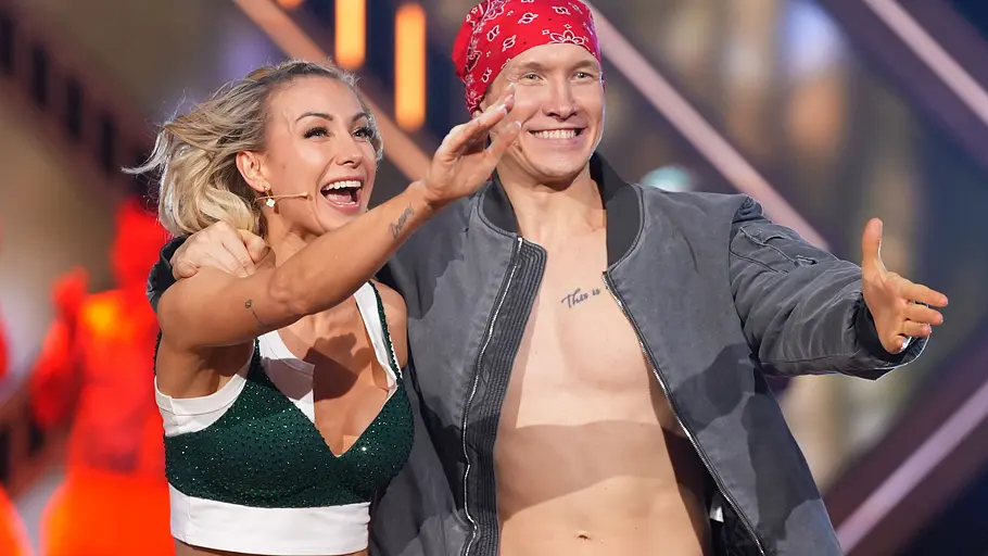 Anna-Carina Woitschack und Evgeny Vinokurov mit ausgestreckten Armen auf dem Parkett.