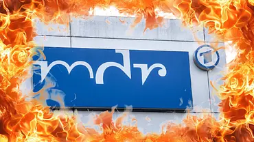 Das MDR-Gogo an einem Bürogebäude, darum ein Ring aus Feuer. - Foto: IMAGO / Bild13 / David Kreuzberg Das MDR-Gogo an einem Bürogebäude, darum ein Ring aus Feuer. - Foto: IMAGO / Bild13 / David Kreuzberg