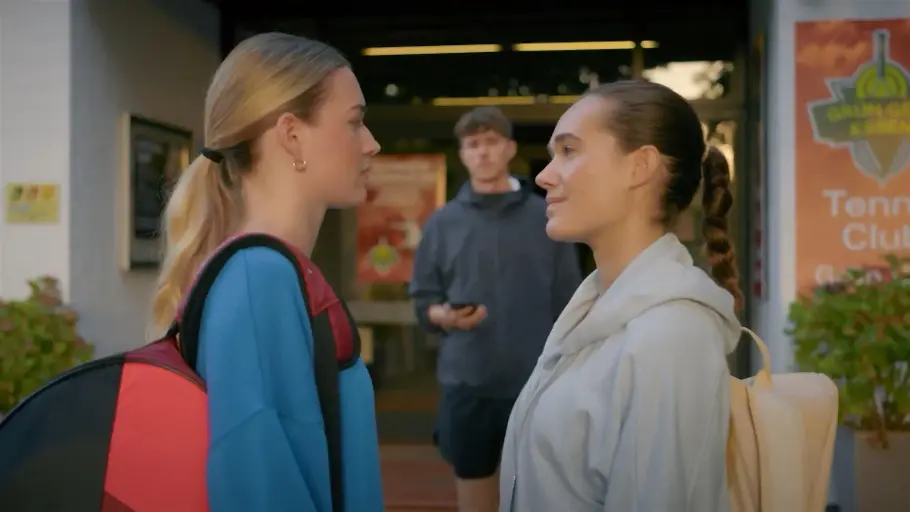 Joana und Nele schauen einander ernst an. Elias steht zwischen ihnen und schaut ebenso ernst.