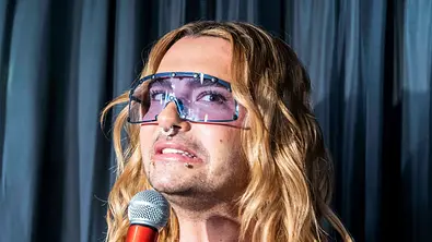 Bill Kaulitz trägt eine blau getönte Sonnenbrille und offene Haare. Er zieht die Mundwinkel nach unten. - Foto: IMAGO / BREUEL-BILD Bill Kaulitz trägt eine blau getönte Sonnenbrille und offene Haare. Er zieht die Mundwinkel nach unten. - Foto: IMAGO / BREUEL-BILD