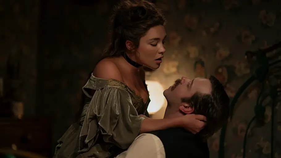 Cathy wurde ebenfalls von Steinbeck erfunden. Florence Pugh als Cathy Ames beugt sich in einem schulterfreien Kleid über einen zurückgelehnten Mann und hält seinen Kopf.