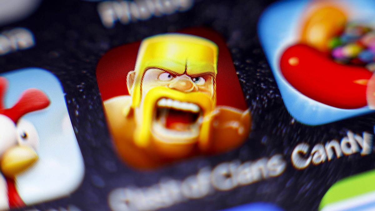 Clash of Clans bald als Serie Man sieht auf einem Handy drei Apps: Hay Day, Clash of Clans und Candy Crush.