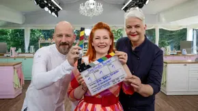 Christian Hümbs, Enie van de Meiklokjes und Bettina Schliephake-Burchardt stehen im Backzelt von „Das große Backen – Die Profis“ und halten eine Filmklappe. - Foto: Joyn / Claudius Pflug Christian Hümbs, Enie van de Meiklokjes und Bettina Schliephake-Burchardt stehen im Backzelt von „Das große Backen – Die Profis“ und halten eine Filmklappe. - Foto: Joyn / Claudius Pflug