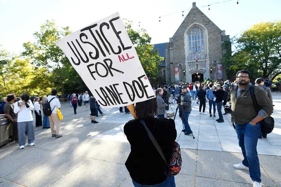 Der Fall Jane Doe sorgte für große Aufmerksamkeit. Eine Person hält ein Schild mit „Justice for all Jane Does“ hoch. Im Hintergrund stehen Menschen und Kamerateams.
