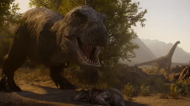 Ein an einen T-Rex anmutender Dinosaurier brüllt. Im Hintergrund sieht man einen Dinosaurier, der einem Brachiosaurus ähnelt. - Foto: Courtesy of Netflix
