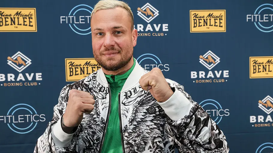 Eric Sindermann Eric Sindermann im bunten Outfit mit gehobener Faust.