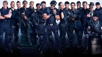 Sylvester Stallone (Mitte) ist von zahlreichen Action-Stars umgeben. Alle tragen militärische Klamotten. - Foto:  IMAGO / Capital Pictures