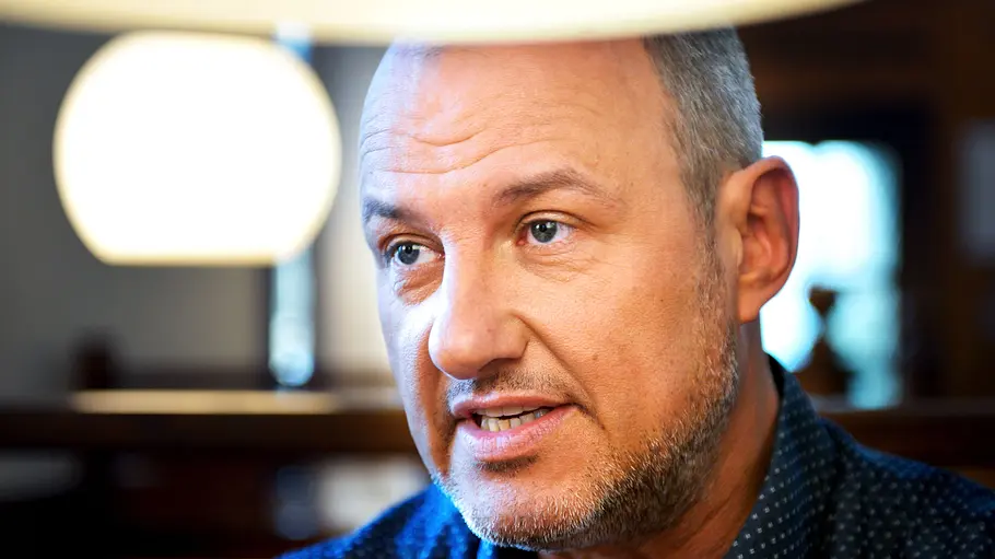Frank Rosin Rettung vom Orgelstübchen in Kornburg gescheitert. Frank Rosin mit kurzen grauen Haaren und Bart trägt ein dunkelblaues Hemd. Helle Lampenschirme sind über und hinter ihm zu sehen.