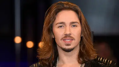 Porträt von Gil Ofarim mit langen braunen Haaren und Bart. Der Musiker trägt eine schwarze Lederjacke und blickt in die Kamera. - Foto: IMAGO/stefanie.dietzel