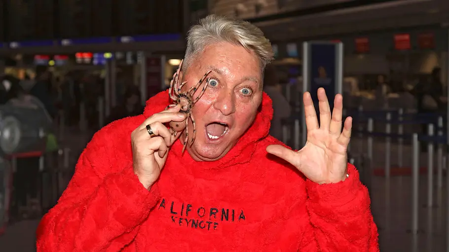 Hubert Fella Hubert Fella ist am Flughafen, er hält eine Plastikspinne in der Hand und tut erschrocken.