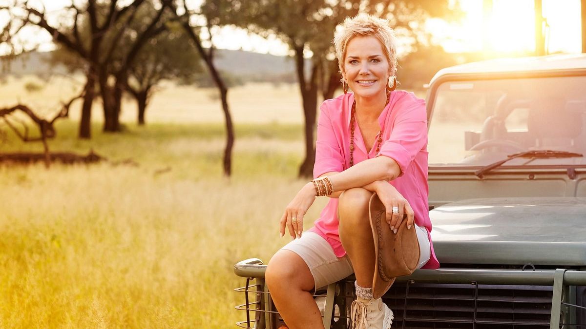 Inka Bause in „Bauer sucht Frau“ Inka Bause posiert vor einem Jeep in der afrikanischen Landschaft
