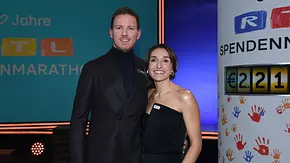 Julian Nagelsmann und Lena Wurzenberger stehen nebeneinander auf einer Bühne und lächeln in die Kamera. Im Hintergrund ist eine Veranstaltungskulisse mit „RTL Spendenmarathon“ zu sehen. - Foto: IMAGO / Revierfoto