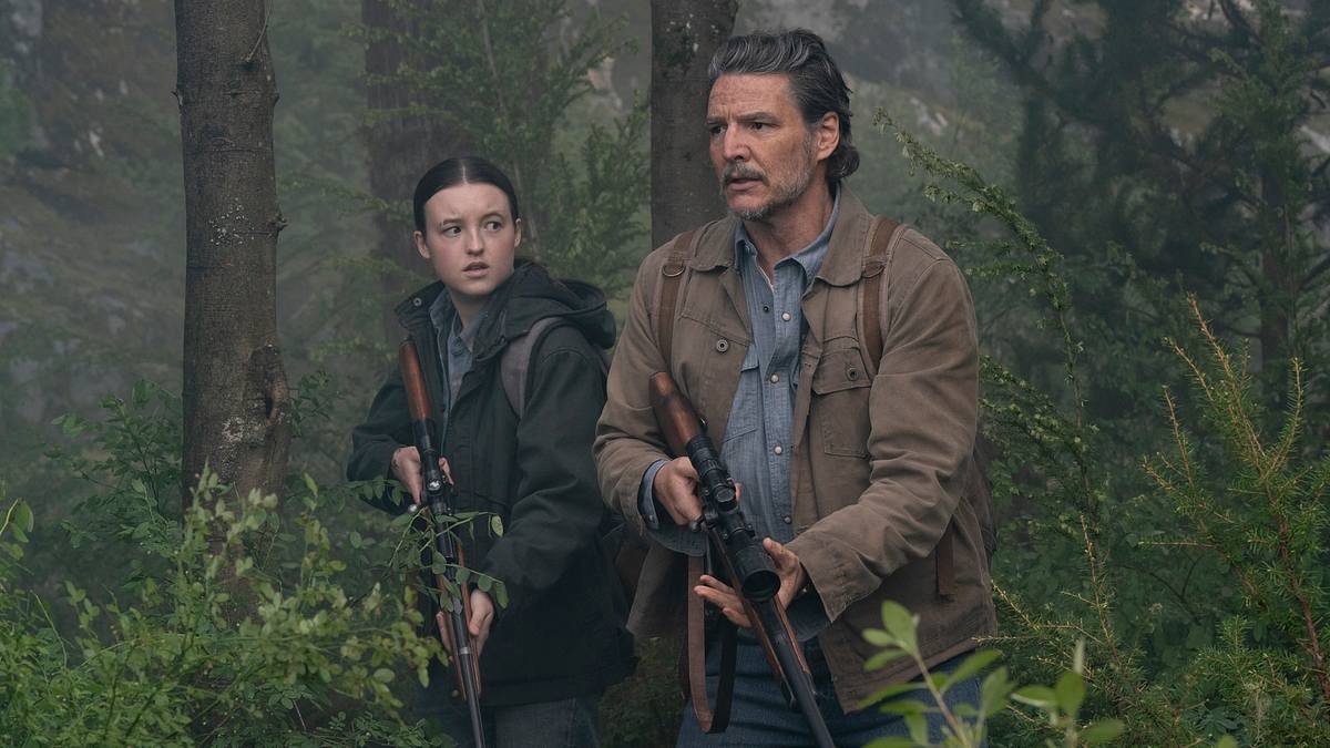 The Last of Us - Staffel 2, Episode 6 Ellie und Joel streifen bewaffnet durch einen Wald.