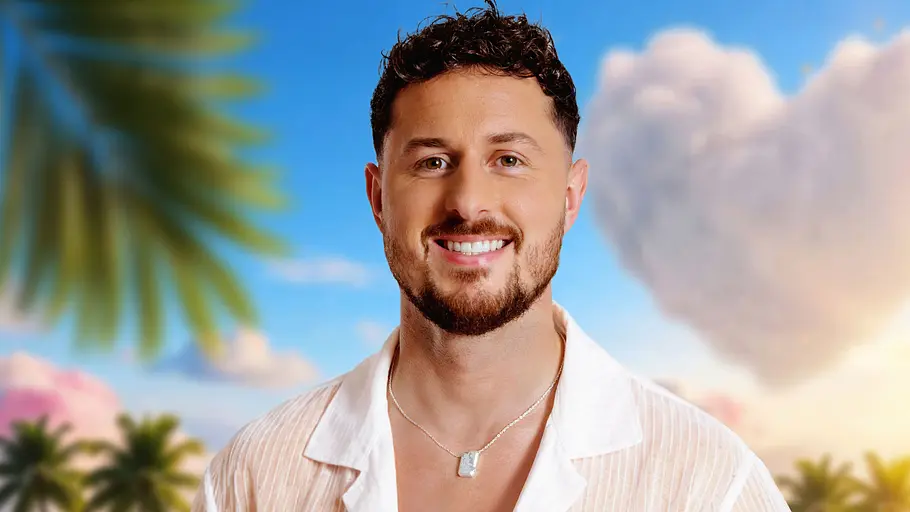 Kaulitz-Flirt Jannik Kontalis versucht sein Glück. Jannik Kontalis lächelt vor Palmen-Hintergrund.