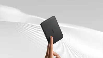 Eine Hand hält eine sehr schlanke Powerbank zwischen zwei Fingern. - Foto: Amazon/PR