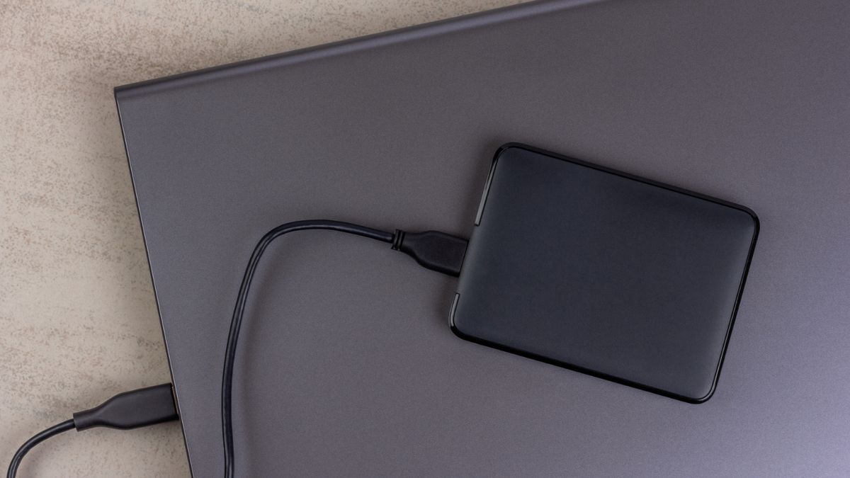 SSD Festplatten Stiftung Warentest Eine SSD-Festplatte liegt auf einem zugeklappten Laptop.