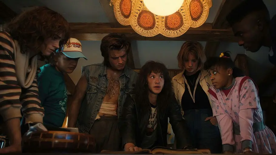 „Stranger Things“-Enttäuschung Der Cast von „Stranger Things“ steht in einer Szene um einen Tisch versammelt.