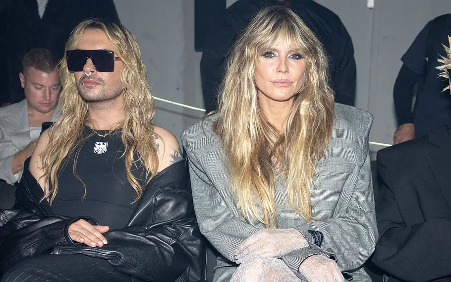 Streit bei Heidi Klum und Bill Kaulitz? Bill und Heidi sitzend nebeneinander. Bill mit Sonnenbrille, Blick von Heidi weg. Heidi guckt starr in die Kamera.