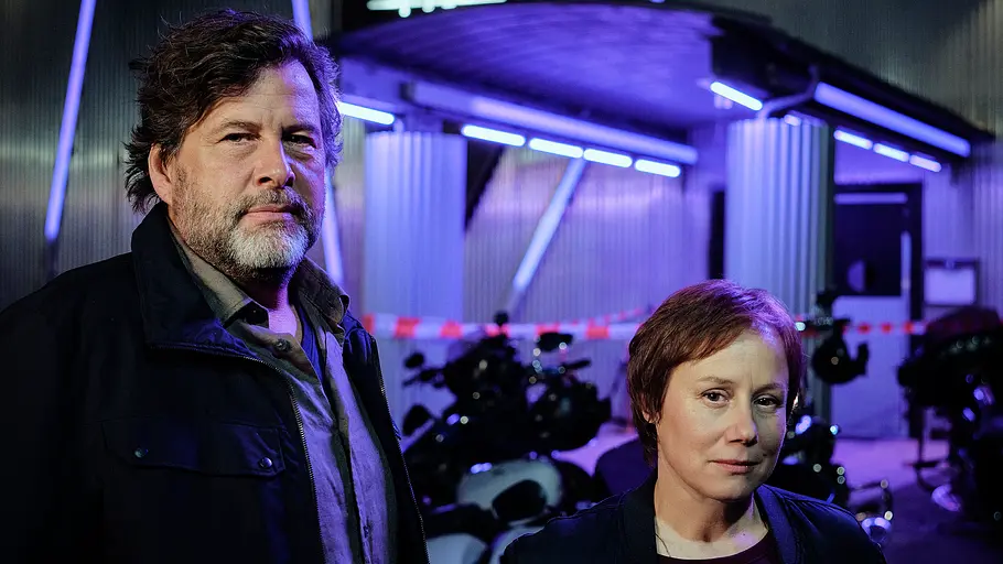 Hans-Jochen Wagner (l.) und Eva Löbau stehen vor Neonlichtern. 