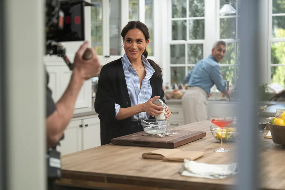 With Love, Meghan Herzogin Meghan Markle steht mit einem Mann in einer Küche und wird gefilmt.