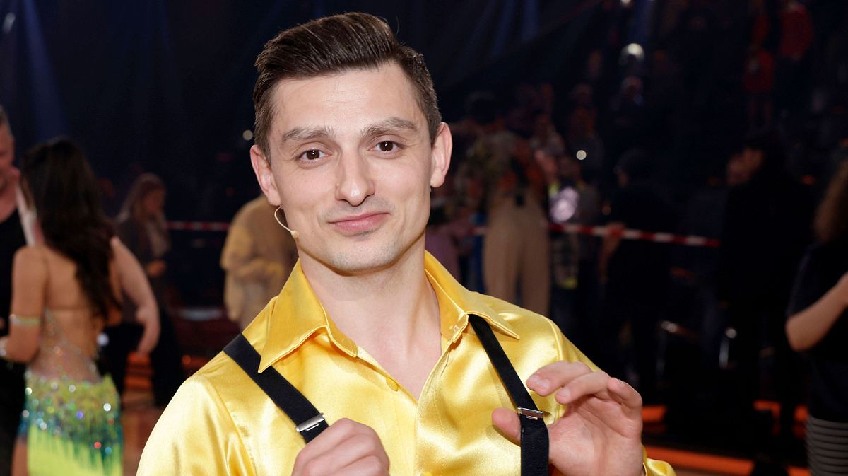 Zsolt Cseke Zsolt Cseke in einem gelben Hand mit Hosenträgern